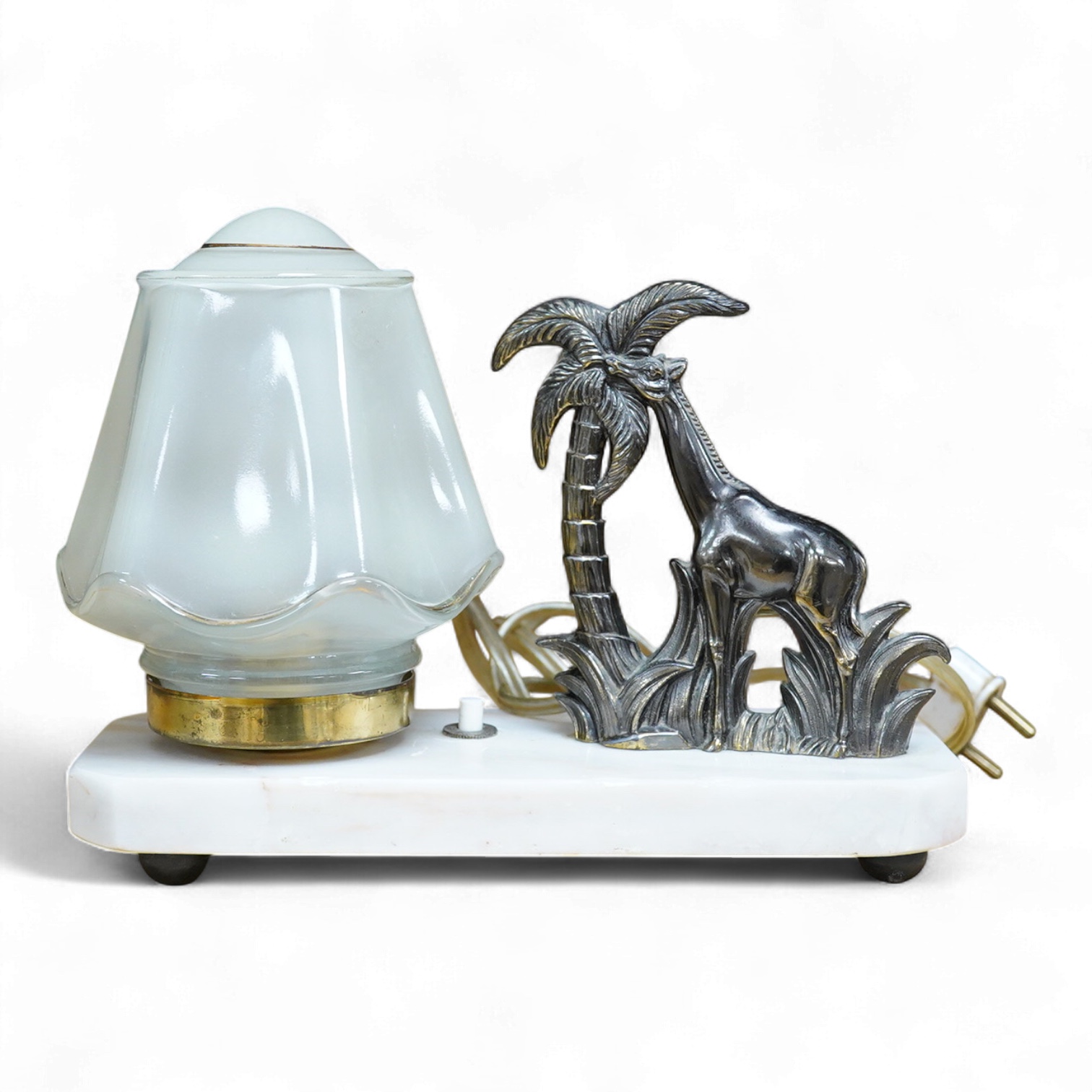 An Art Deco lamp with opaque glass shade, surmounted with a giraffe, 20cm wide